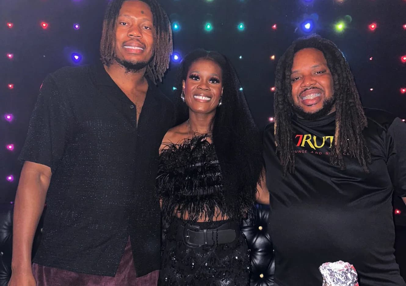 Guests together at Truth Lounge in front of the TRUTH backdrop